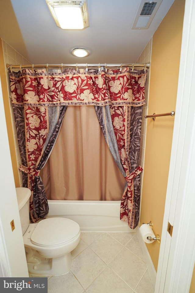 bathroom featuring tile flooring, shower / bath combination with curtain, and toilet