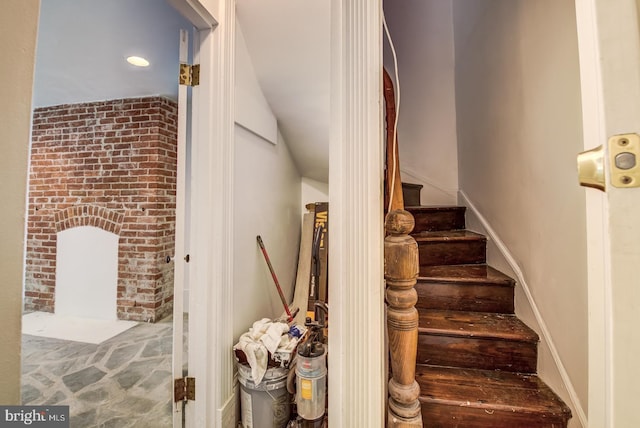 staircase featuring a fireplace