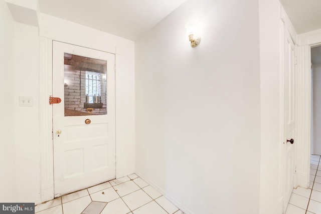 doorway to outside with light tile patterned flooring