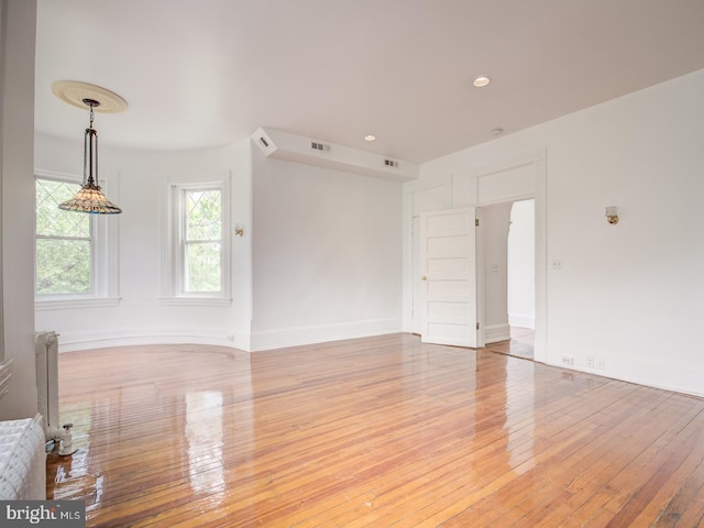 empty room with light hardwood / wood-style flooring