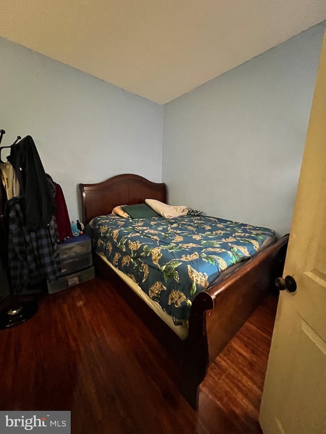 bedroom with dark wood finished floors