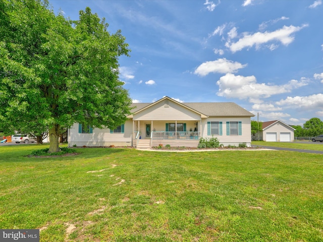 single story home featuring a porch, an outbuilding, and a front yard