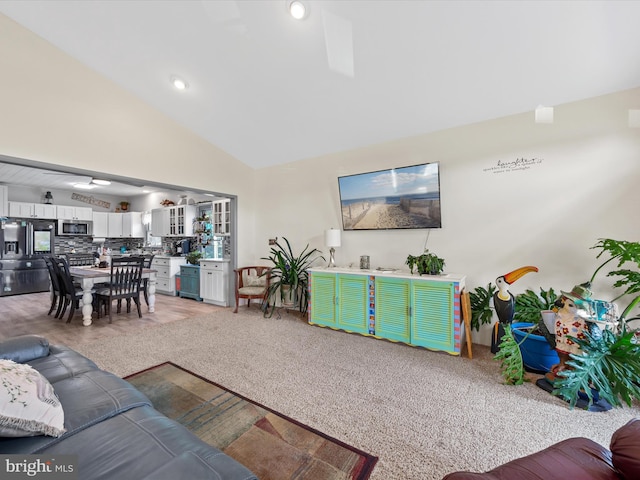 living room with light carpet and vaulted ceiling