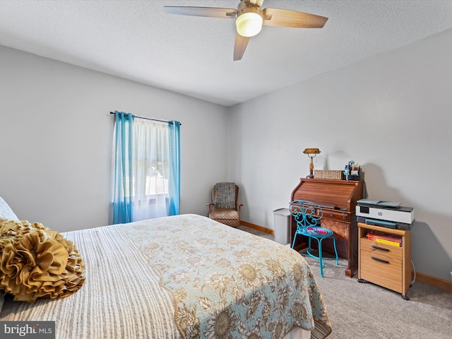 carpeted bedroom with ceiling fan and a textured ceiling