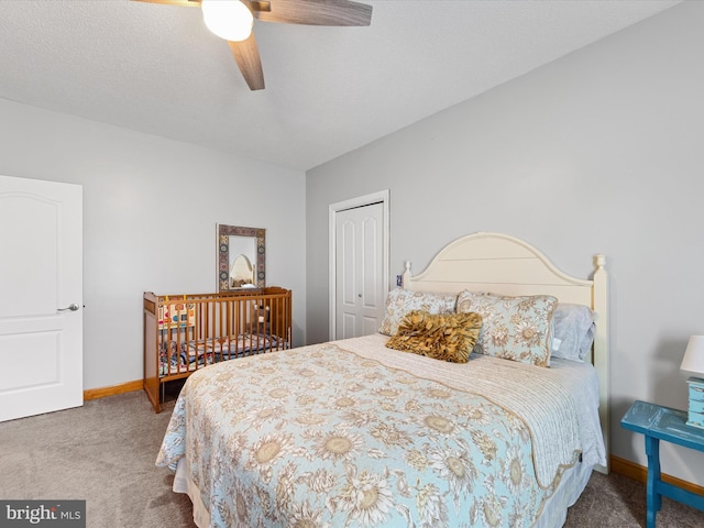 bedroom featuring carpet flooring, a textured ceiling, a closet, and ceiling fan