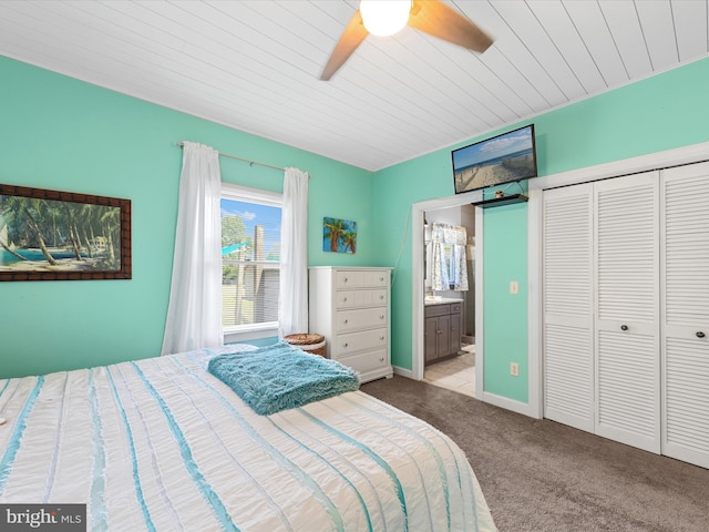 bedroom with ensuite bath, ceiling fan, wooden ceiling, light carpet, and a closet