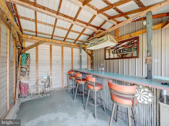 interior space with concrete floors and vaulted ceiling