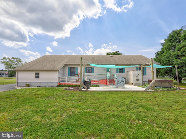 back of house with a jacuzzi, a yard, and a patio area