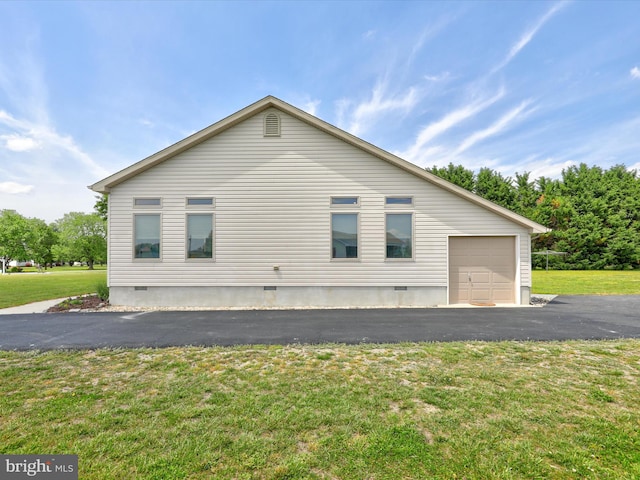 view of side of home with a yard