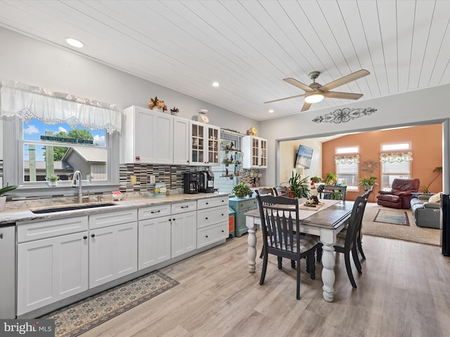 kitchen featuring a wealth of natural light, sink, and white cabinets