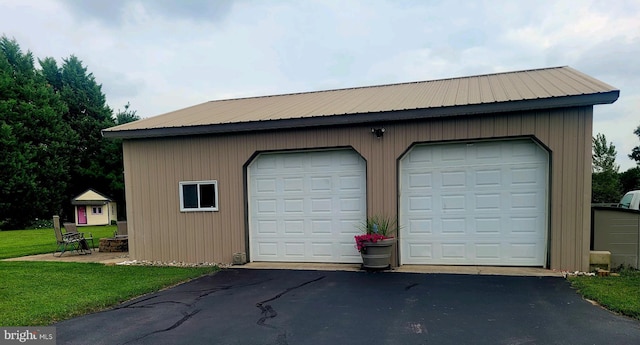 garage featuring a lawn