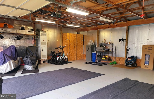 garage with a garage door opener and wooden walls