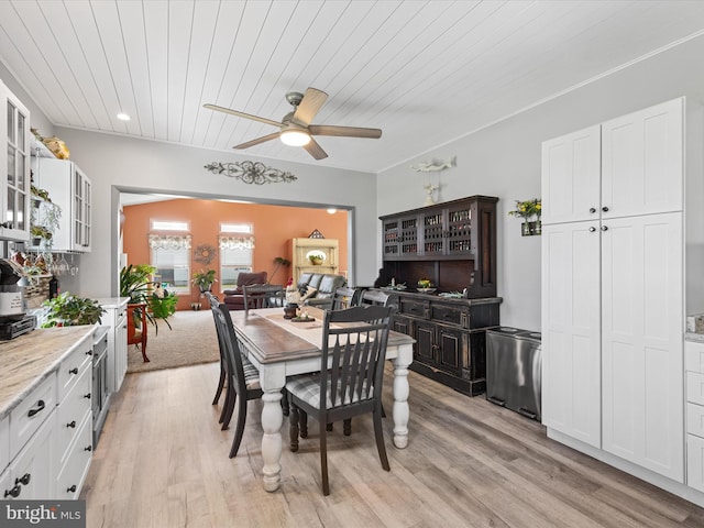 dining space featuring ceiling fan, wood ceiling, and light wood-type flooring