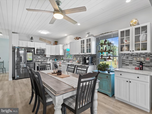 dining area with ceiling fan, light wood-type flooring, and wood ceiling