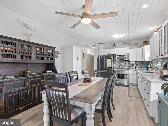 dining space with wooden ceiling, sink, ceiling fan, ornamental molding, and light hardwood / wood-style floors