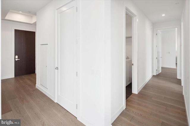 hall with hardwood / wood-style flooring