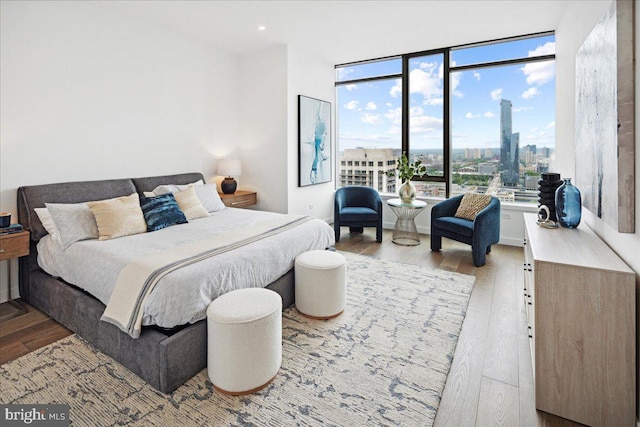 bedroom featuring hardwood / wood-style flooring and floor to ceiling windows