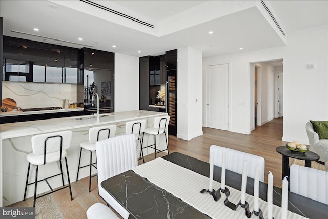 dining space featuring light hardwood / wood-style floors and sink