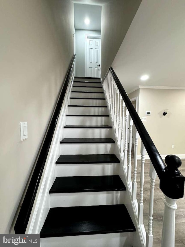 stairs featuring crown molding