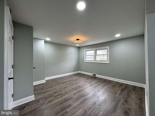 spare room with dark hardwood / wood-style floors