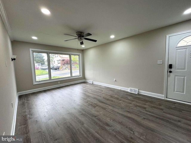 spare room featuring dark hardwood / wood-style flooring and ceiling fan