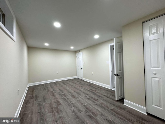 basement with dark hardwood / wood-style floors