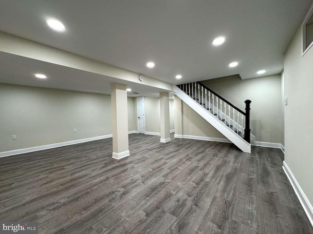 basement featuring dark hardwood / wood-style flooring