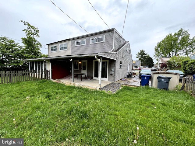 back of property featuring a yard and a patio area