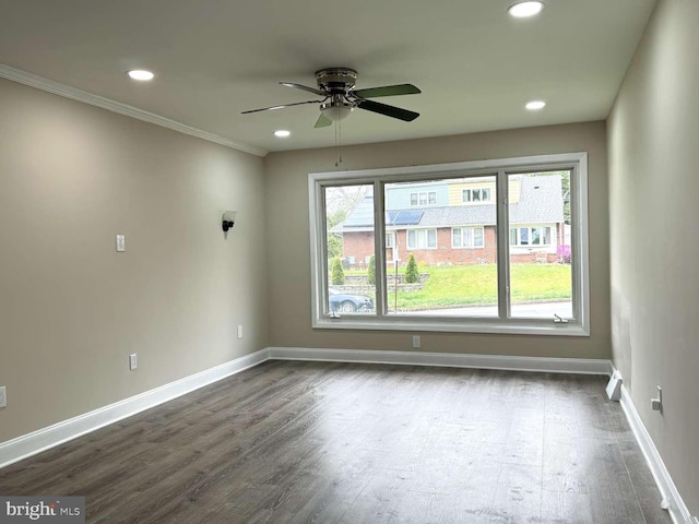 unfurnished room with ceiling fan, a wealth of natural light, and dark hardwood / wood-style flooring