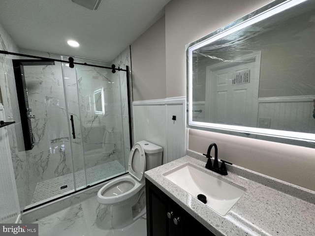 bathroom featuring tile flooring, vanity, toilet, and a shower with shower door