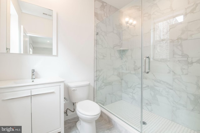 bathroom featuring an enclosed shower, vanity, tile floors, and toilet