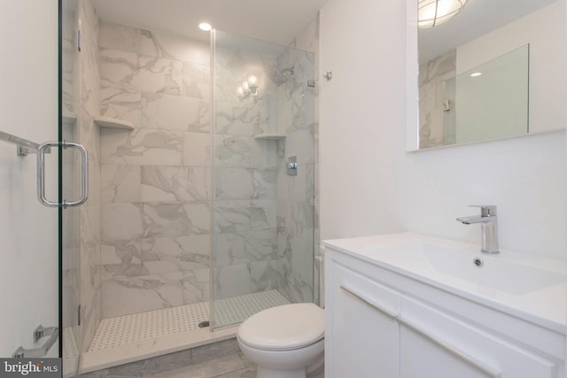 bathroom with oversized vanity, a shower with shower door, tile floors, and toilet