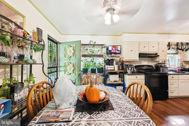 dining room with dark hardwood / wood-style flooring, ceiling fan, and crown molding