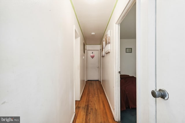 hall with hardwood / wood-style floors