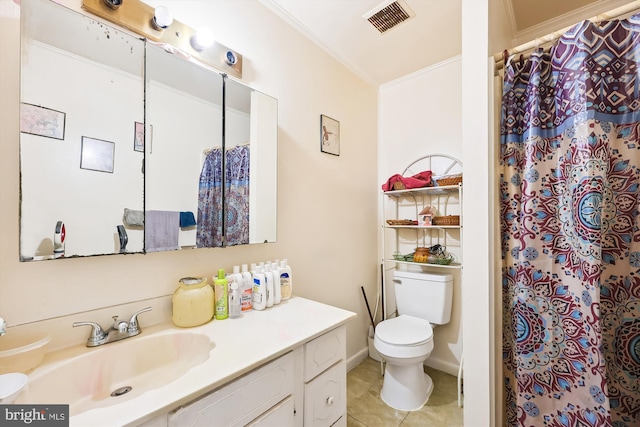 bathroom featuring ornamental molding, tile floors, vanity, and toilet