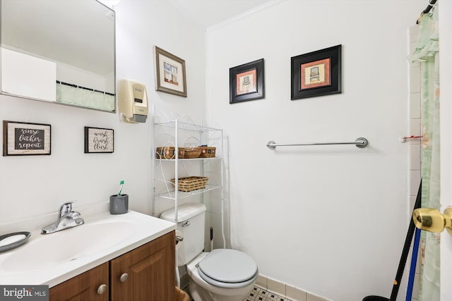 bathroom with vanity, tile floors, toilet, and ornamental molding