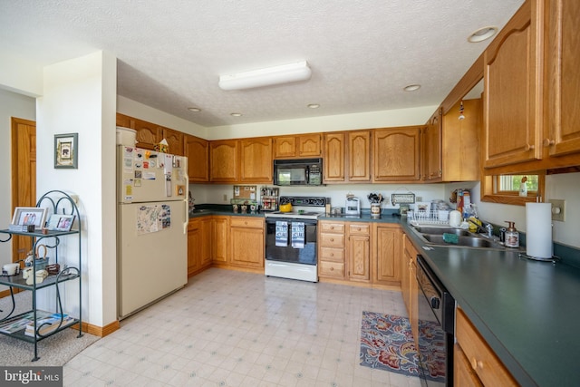 kitchen featuring light tile floors, a textured ceiling, black appliances, and sink