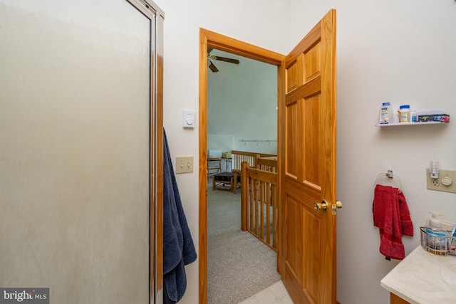 hallway featuring light colored carpet