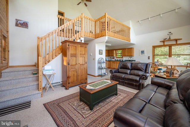 carpeted living room featuring high vaulted ceiling, ceiling fan, and rail lighting