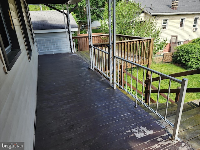 wooden deck featuring a lawn