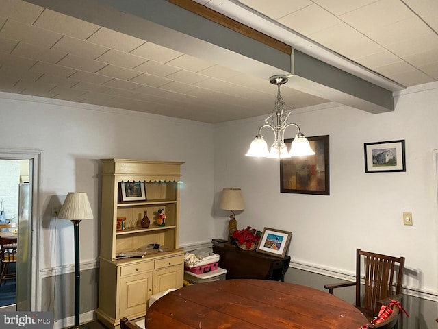 dining area with beamed ceiling and a notable chandelier