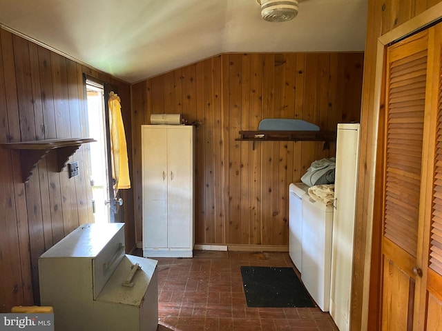 interior space with washing machine and dryer and wooden walls