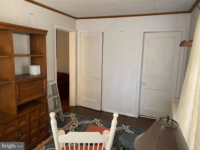 bedroom featuring dark wood-type flooring and ornamental molding