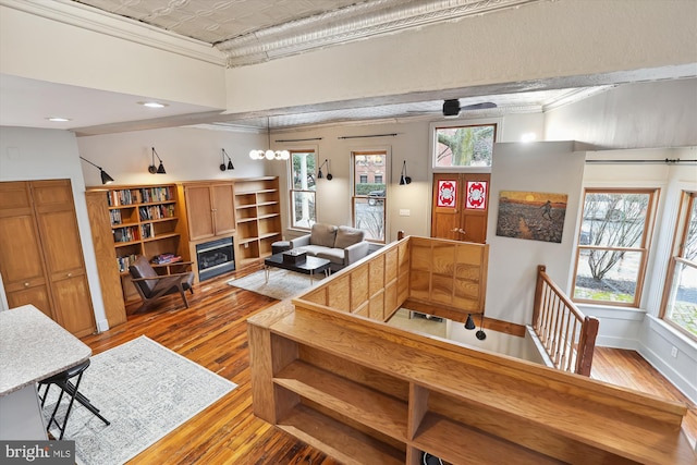 interior space with ceiling fan, light hardwood / wood-style floors, and ornamental molding