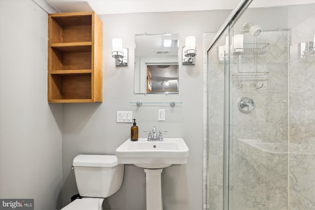 bathroom featuring toilet and walk in shower