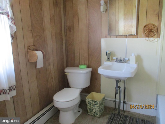 bathroom featuring wood walls and toilet