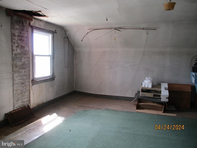 additional living space featuring lofted ceiling