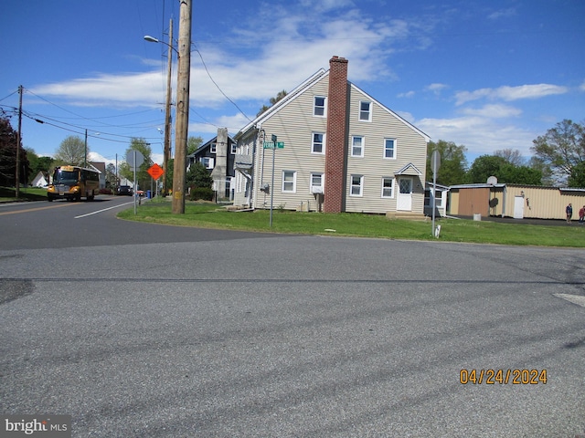 view of property exterior with a lawn