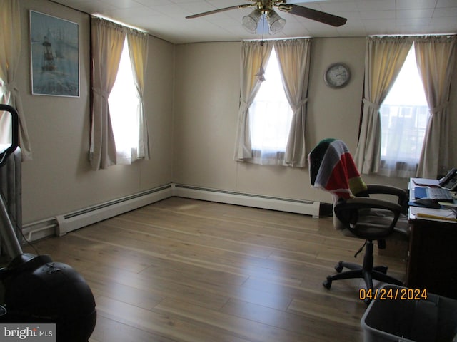 office with hardwood / wood-style floors and a healthy amount of sunlight