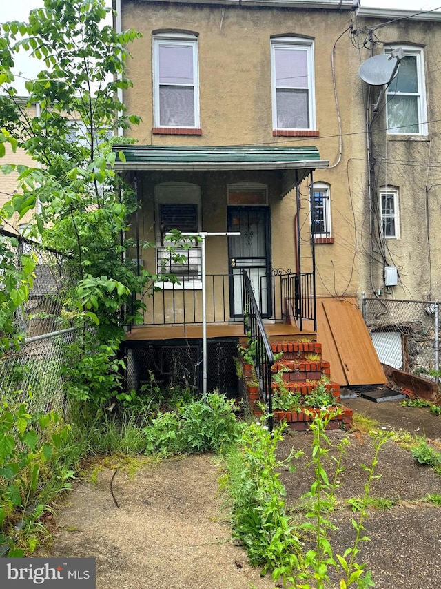 rear view of property with a porch